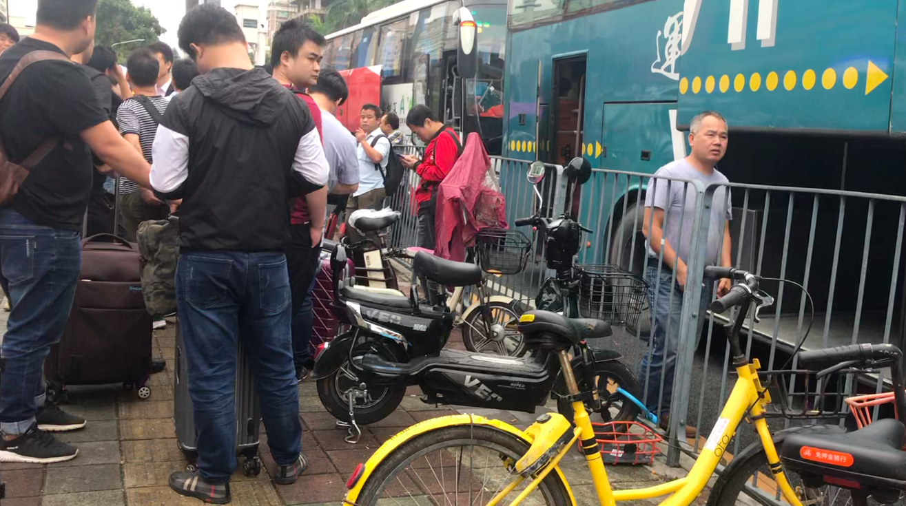 Job seekers are waiting for getting on the buses that will take them to factories