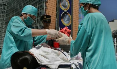 Protesters_simulate_a_surgery_to_remove_an_organ_from_a_Falun_Gong_member_during_a_demonstration_in_front_of_the_European_Council_in_Brussel.jpeg